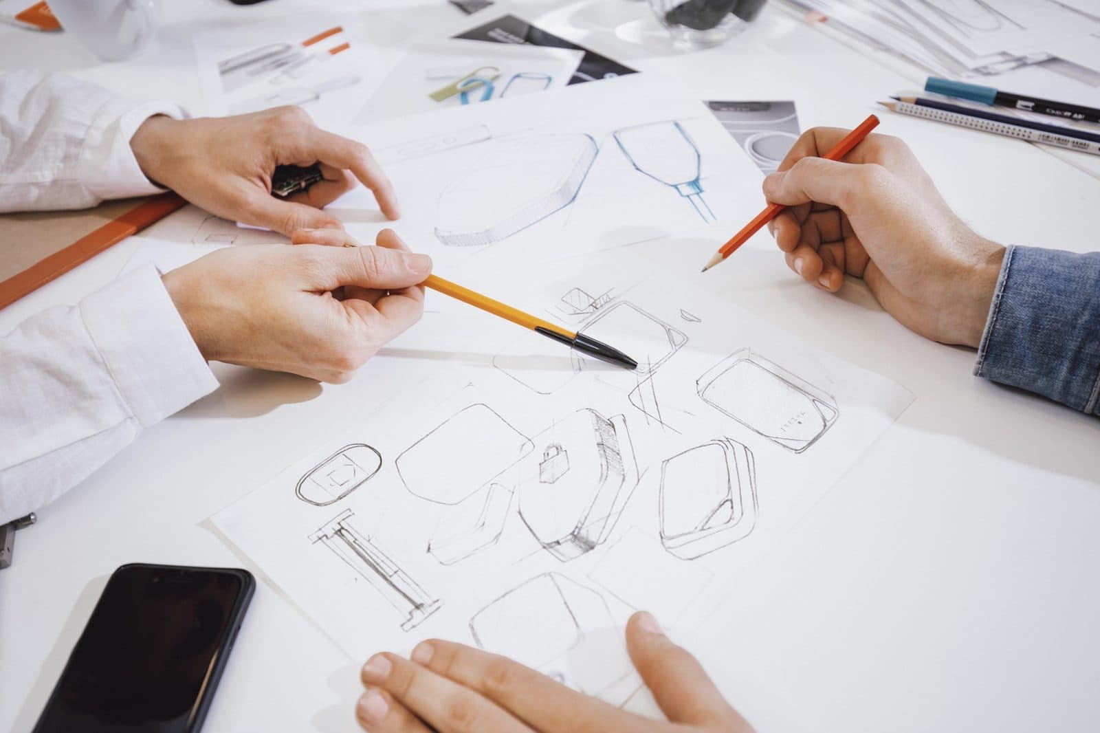 Designers sketching product concepts by hand