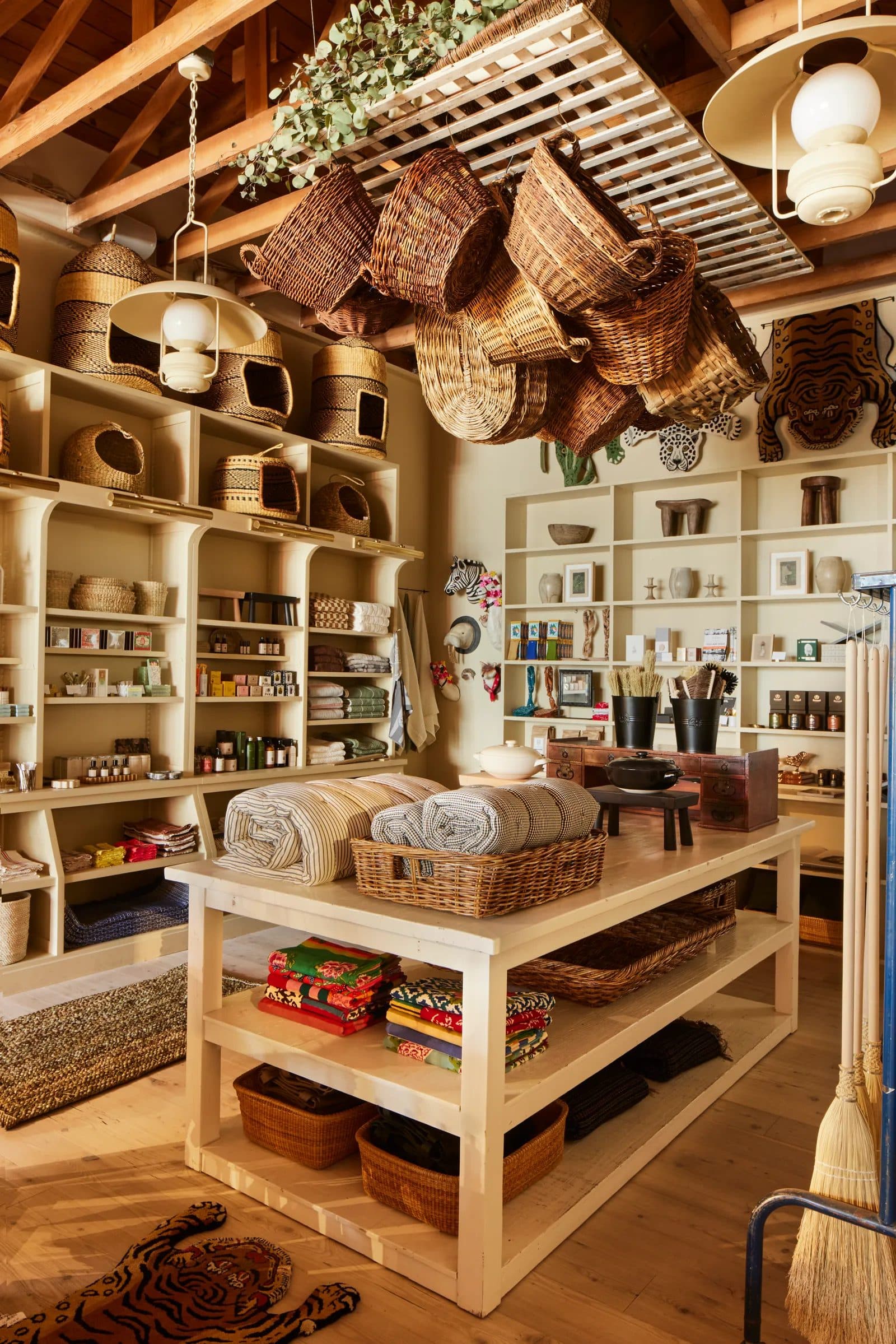 A rustic boho retail shop displaying woven baskets and home textiles